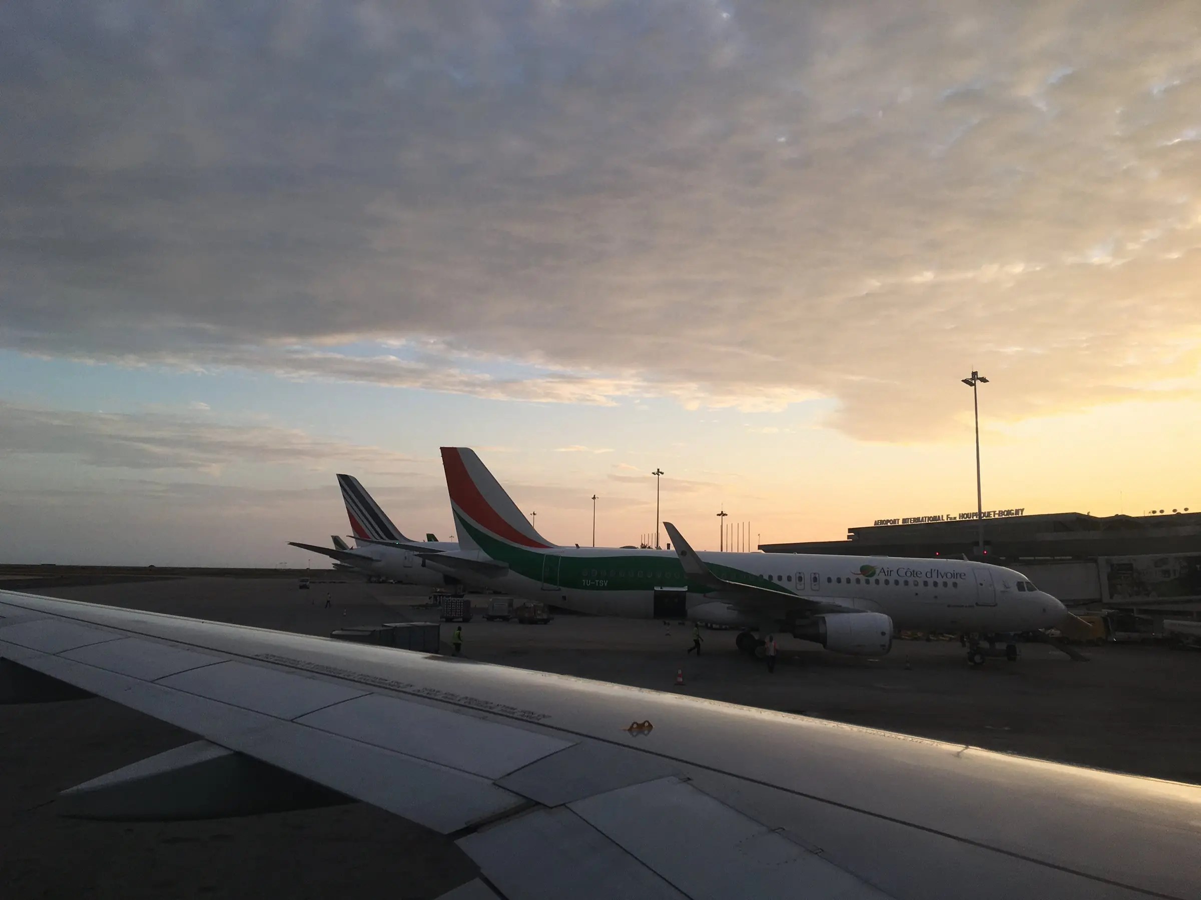 Aéroport Félix-Houphouët-Boigny d’Abidjan au crépuscule, vu depuis le hublot